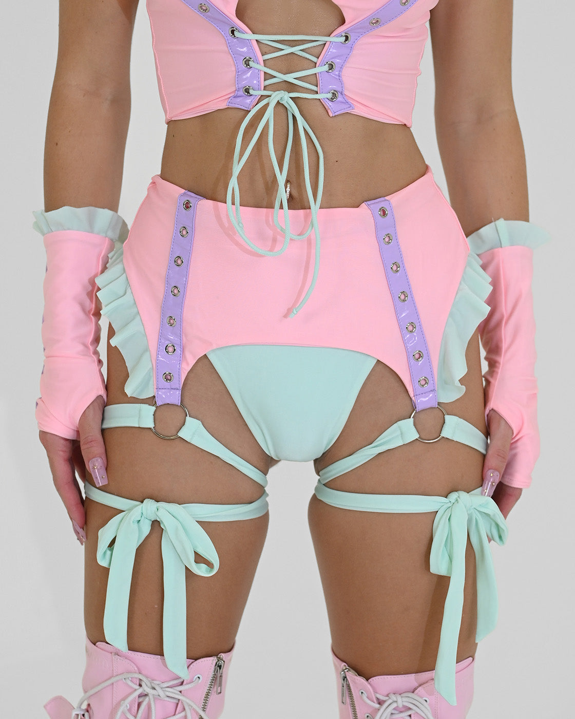 Pastel cotton-candy garter-belt bikini bottoms with mint leg wraps and purple grommet-vinyl accents